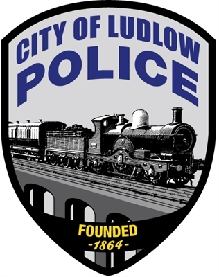 Badge for City of Ludlow Police featuring a steam locomotive on a railroad, with 