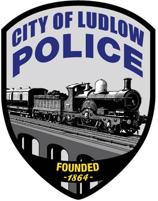 Shield-shaped insignia for the City of Ludlow Police featuring a steam locomotive and the text 