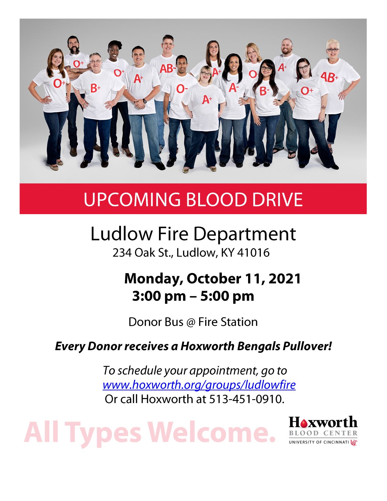 Group of people wearing shirts with blood types stand together promoting a blood drive at Ludlow Fire Department on October 11, 2021.
