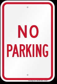 White rectangular sign with red border and text stating 