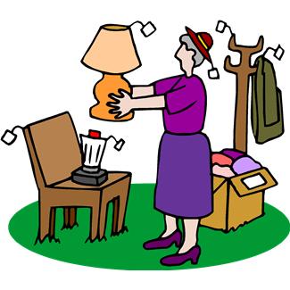 An elderly woman in a purple outfit holds a lamp near a chair with a blender, next to a coat rack and a box of clothes.